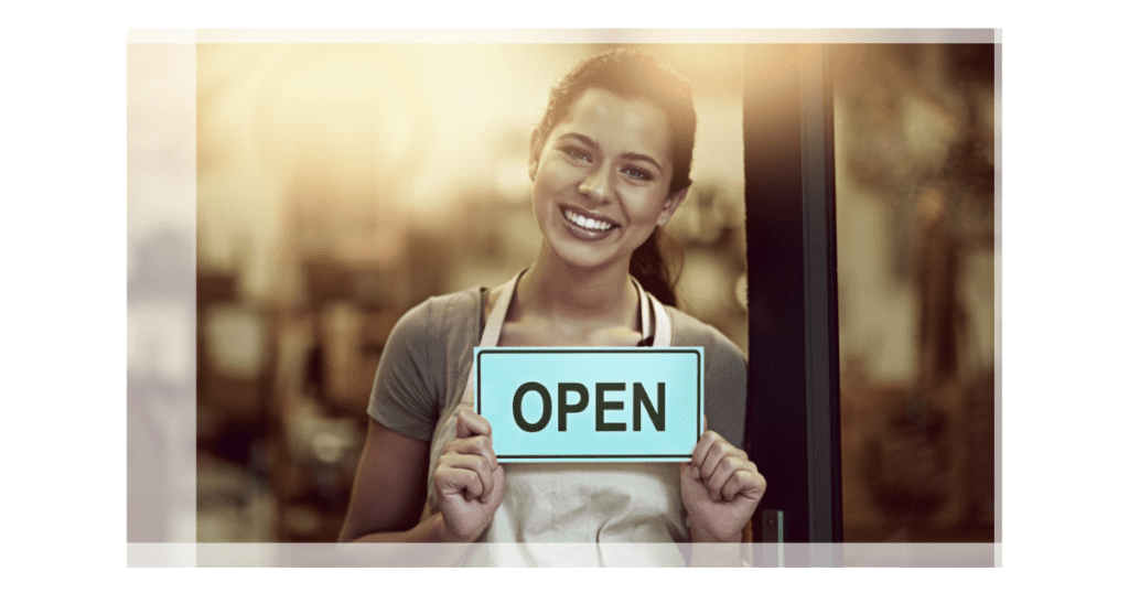 mall Business Owner in Toronto Holding 'Open' Sign