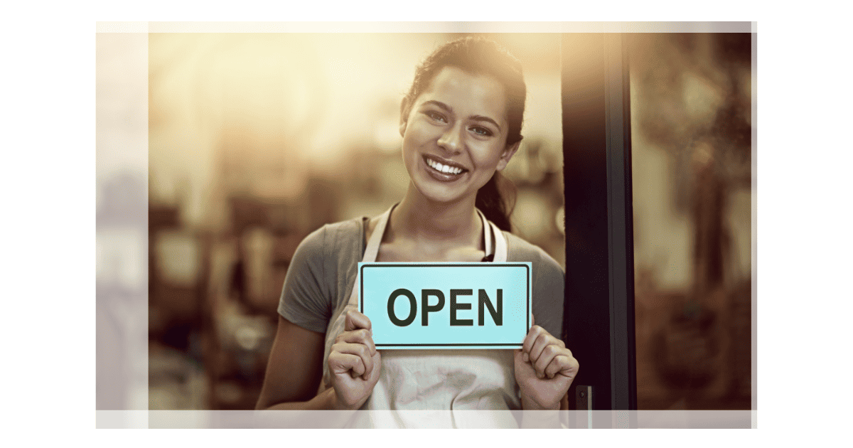 mall Business Owner in Toronto Holding 'Open' Sign